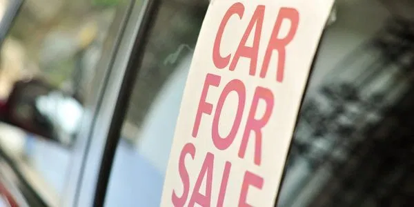 A vehicle with a clear CAR FOR SALE sign representing our brokerage service.