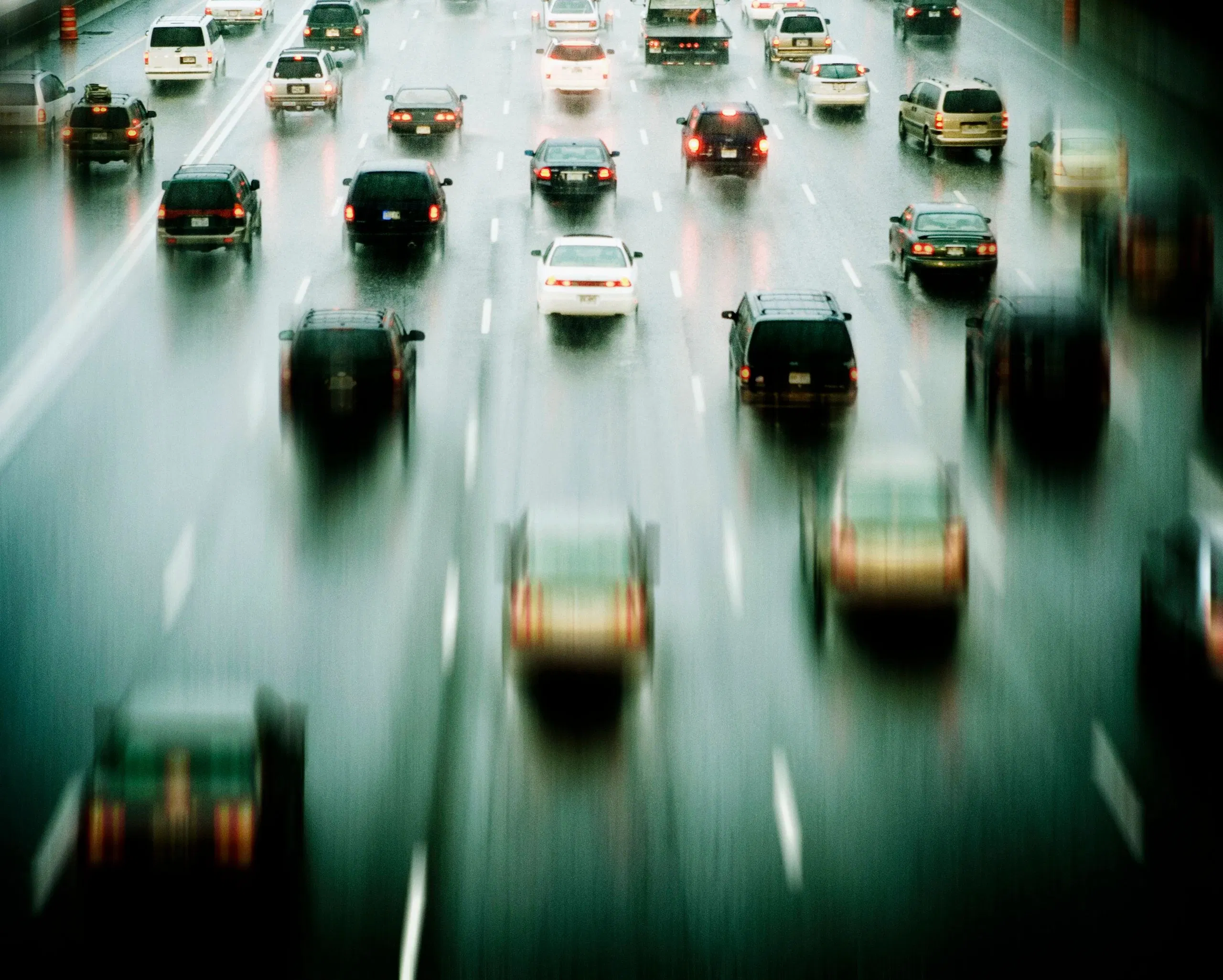 Multiple cars driving along a busy highway, representing demand for professional fleet management.